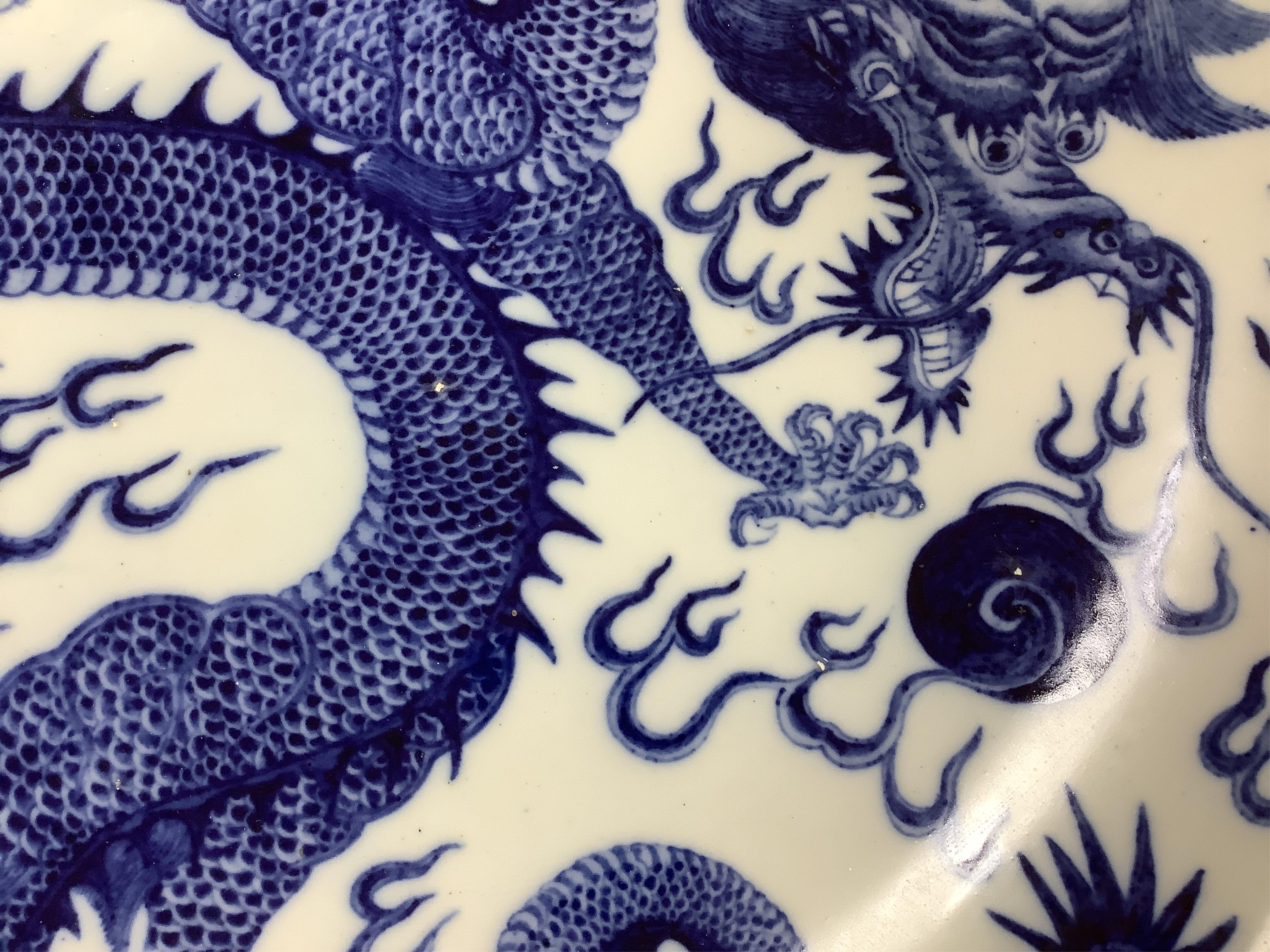 Two large Chinese blue and white chargers, largest 62cm diameter. Condition - good